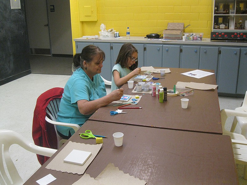 Wake Village Elementary School second-grader Ana Frame and her grandmother, Ruby Frame, paint rainy-day-related pictures Saturday afternoon inside the Discovery Place Interactive Museum. Even though the day was sunny, the museum conducted this "rainy day" activity project as part of its monthly Boredom Busters Activities and Events for children.