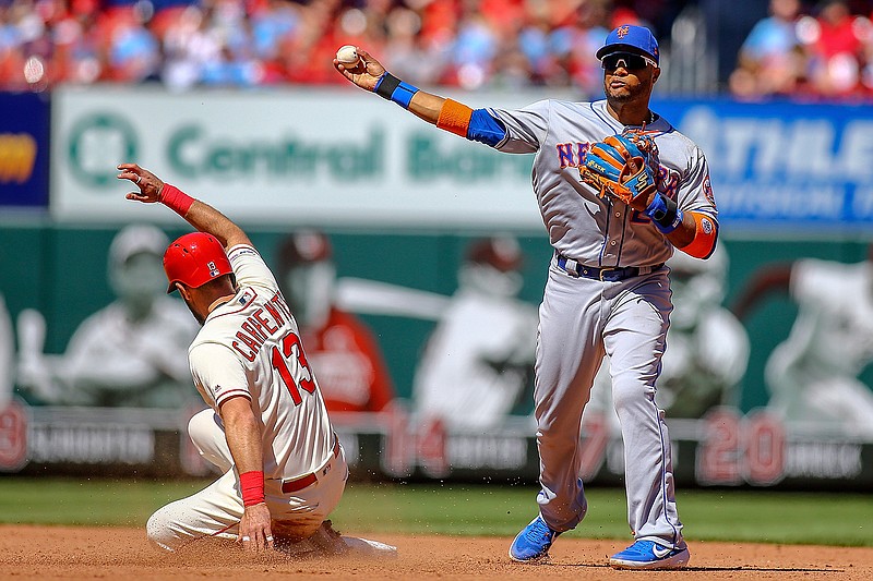 New York Mets second baseman Robinson Cano (24) throws to first base after making an out against St. Louis Cardinals' Matt Carpenter, left, during the fourth inning of a baseball game Saturday, April 20, 2019, in St. Louis. (AP Photo/Scott Kane)