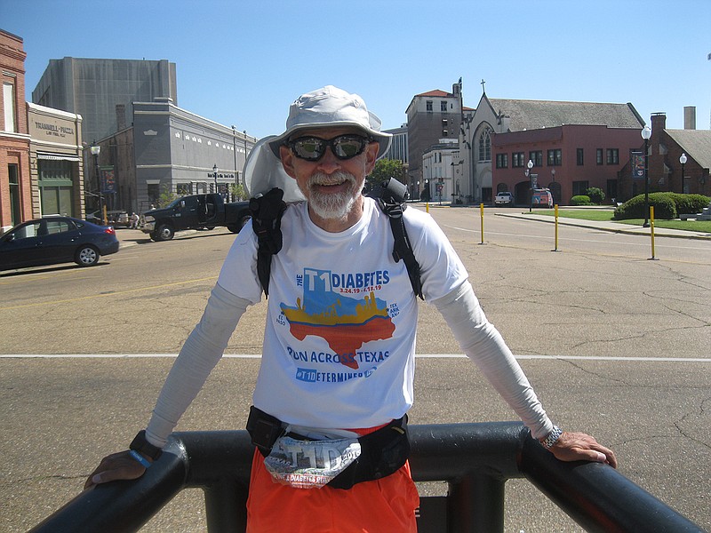 Don Muchow, 57, stands Saturday afternoon in downtown Texarkana after running 850 miles in 28 days across Texas, starting from El Paso on March 24. Muchow hopes to raise awareness of diabetes. Next year, he plans to run from Disney Land in California to Disney World in Florida.