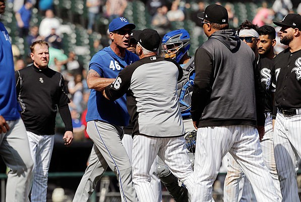 Royals bench coach Dale Sveum and White Sox manager Rick Renteria shove each other as benches clear after Tim Anderson of the White Sox was hit by a pitch during the sixth inning of last Wednesday's game in Chicago.