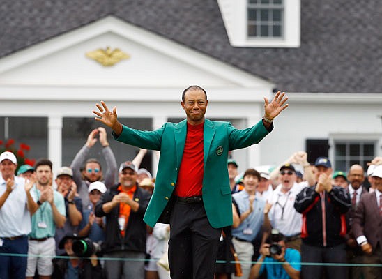 Tiger Woods smiles as he wears his green jacket after winning the Masters last Sunday in Augusta, Ga.