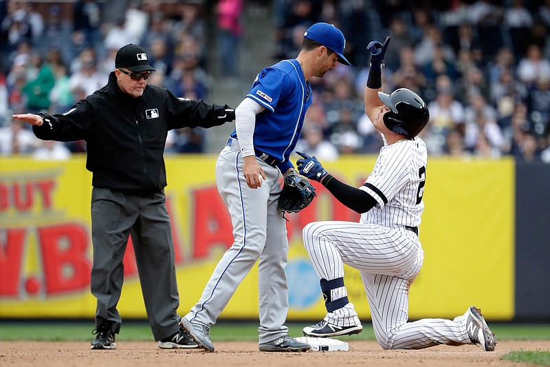 New York Yankees' Gio Urshela, right, gestures after sliding safely into second on a double off Kansas City Royals starting pitcher Glenn Sparkman, not visible, during the seventh inning of a baseball game, Saturday, April 20, 2019, in New York. (AP Photo/Julio Cortez)