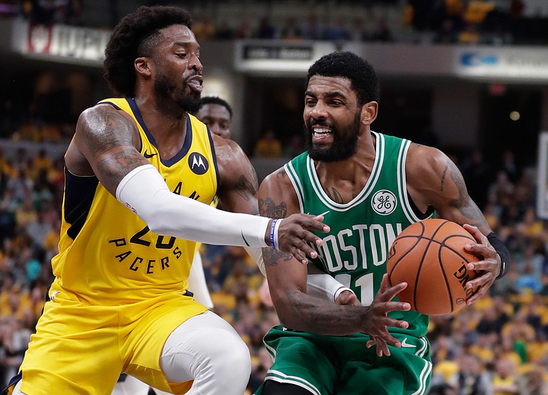  Boston Celtics guard Kyrie Irving, right, is fouled by Indiana Pacers guard Wesley Matthews, left, during the first half of Game 4 of an NBA first-round playoff series Sunday in Indianapolis.