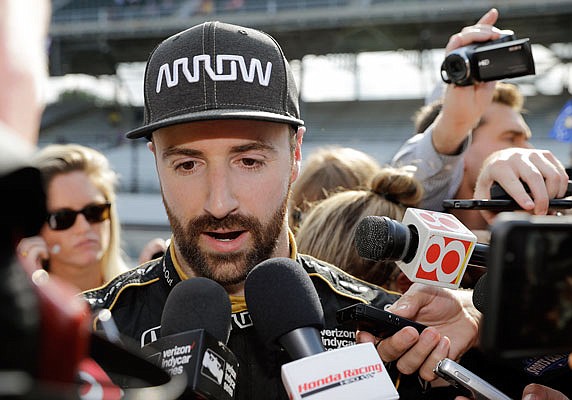 In this May 19, 2018, file photo, James Hinchcliffe talks with the media after failing to qualify for the Indianapolis 500 at Indianapolis Motor Speedway in Indianapolis. Chip Ganassi and Michael Andretti have joined Roger Penske in calling for guaranteed spots in the Indianapolis 500, arguing their financial commitment to IndyCar is too steep to afford missing out on the biggest race of the year.