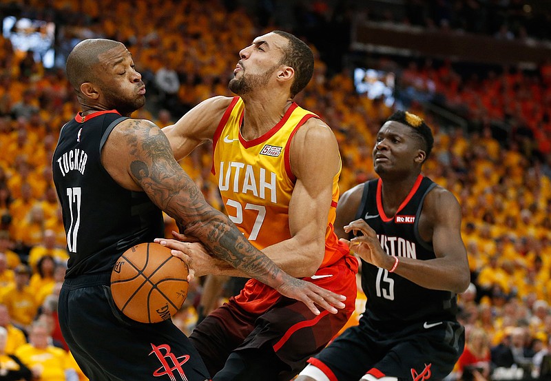  Houston Rockets' PJ Tucker (17) and Clint Capela (15) defend against Utah Jazz center Rudy Gobert (27) Saturday in Salt Lake City. 