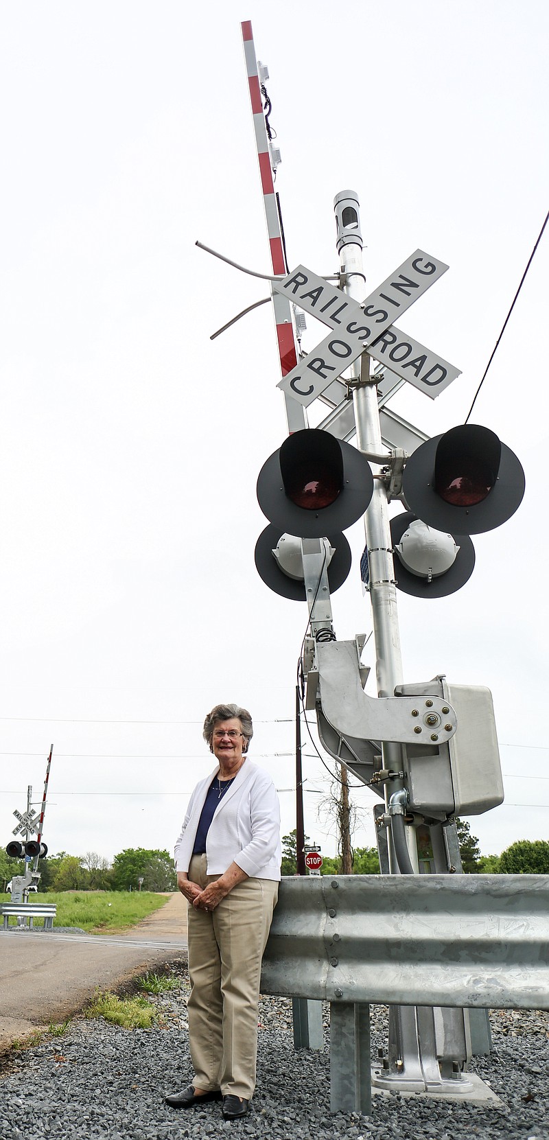 Ogden Mayor Sandra Furlow poses for a portrait next to the newly installed railroad crossing guard Wednesday in Odgen, Ark.