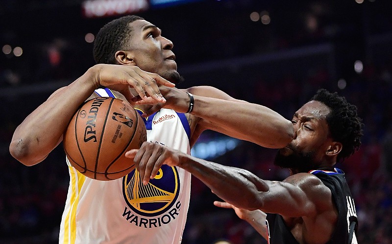 Los Angeles Clippers guard Patrick Beverley, right, knocks the ball from the hands of Golden State Warriors center Kevon Looney during Game 4 of a first-round NBA playoff series Sunday in Los Angeles. The Warriors won, 113-105. 