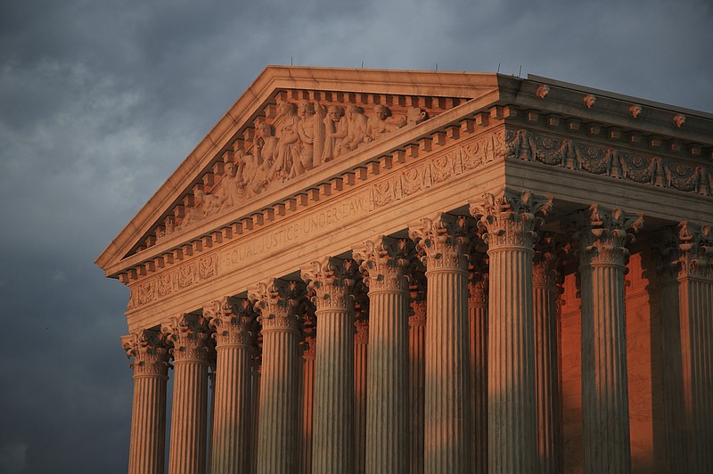 FILE - In this Oct. 4, 2018 file photo, the U.S. Supreme Court is seen at sunset in Washington.  The Supreme Court will decide whether the main federal civil rights law that prohibits employment discrimination applies to LGBT people. The justices say Monday they will hear cases involving people who claim they were fired because of their sexual orientation.  (AP Photo/Manuel Balce Ceneta)