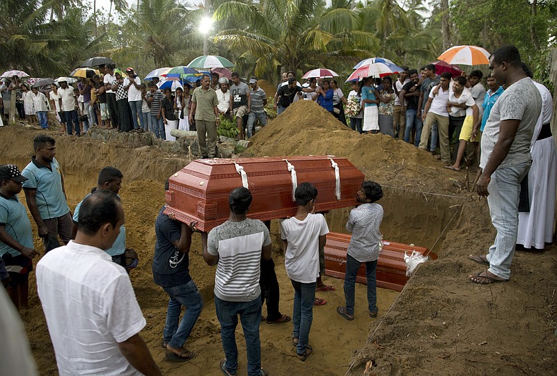 Relatives carry a coffin for burial during the funerals of three members of the same family, all died at Easter Sunday bomb blast at St. Sebastian Church in Negombo, Sri Lanka, Monday, April 22, 2019. Easter Sunday bombings of churches, luxury hotels and other sites was Sri Lanka's deadliest violence since a devastating civil war in the South Asian island nation ended a decade ago. (AP Photo/Gemunu Amarasinghe)