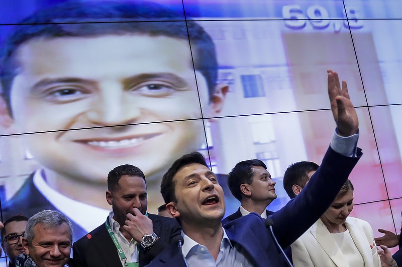 In this photo taken on Sunday, April 21, 2019, Ukrainian comedian and presidential candidate Volodymyr Zelenskiy gestures while speaking at his headquarters after the second round of presidential elections in Kiev, Ukraine. For his presidential campaign popular Ukrainian comedian Volodymyr Zelenskiy has literally taken the script from a TV show in which he plays the Ukrainian president. (AP Photo/Sergei Grits)