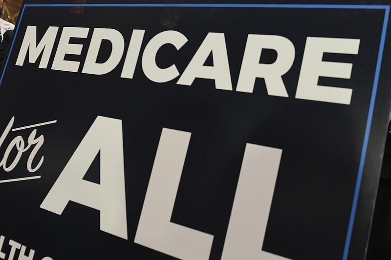 FILE - In this April 10, 2019 file photo, a sign is shown during a news conference to reintroduce  "Medicare for All" legislation, on Capitol Hill in Washington. The financial condition of the government’s bedrock retirement programs for middle- and working-class Americans remain shaky, with Medicare pointed toward insolvency by 2026. That’s the word from the latest report by the government’s overseers of Medicare and Social Security, which paints a sobering picture of the programs, though it’s relatively unchanged from last year’s update. Social Security would become insolvent in 2035, one year later than previously estimated.  (AP Photo/Susan Walsh)