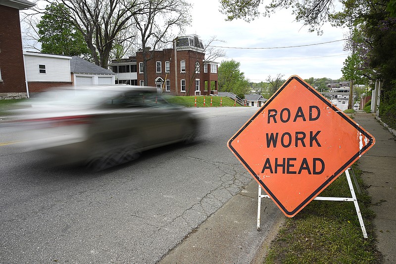 A car drives past a road work sign Monday, April 22, 2019, along Dunklin Street. Jefferson City and Cole County funded the improvement project on the street.