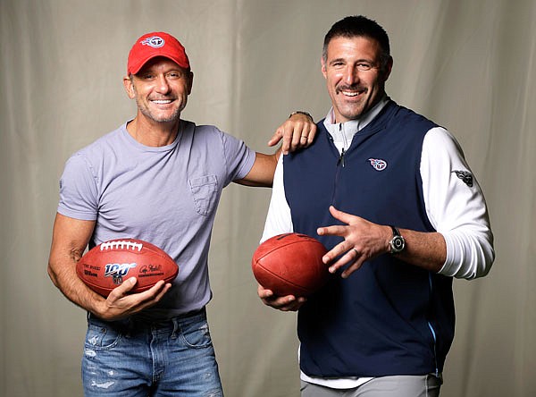 Country music star Tim McGraw, left, poses with Titans head coach Mike Vrabel last week in Nashville, Tenn. After the second day of the NFL Draft on Friday in Nashville, McGraw will cap the evening performing on the draft stage across the Cumberland River from Nissan Stadium, home of the Titans.