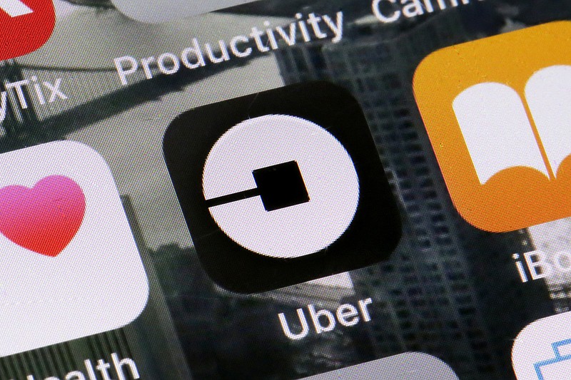 FILE - This Tuesday, June 12, 2018, file photo shows the Uber app on a phone in New York. Uber on Thursday, April 18, 2019, said that it is releasing a new feature to help riders ensure they’re getting into the right vehicles. The development comes several weeks after a University of South Carolina student was killed after getting into a car she had mistaken for the Uber ride she hailed. (AP Photo/Richard Drew, File)