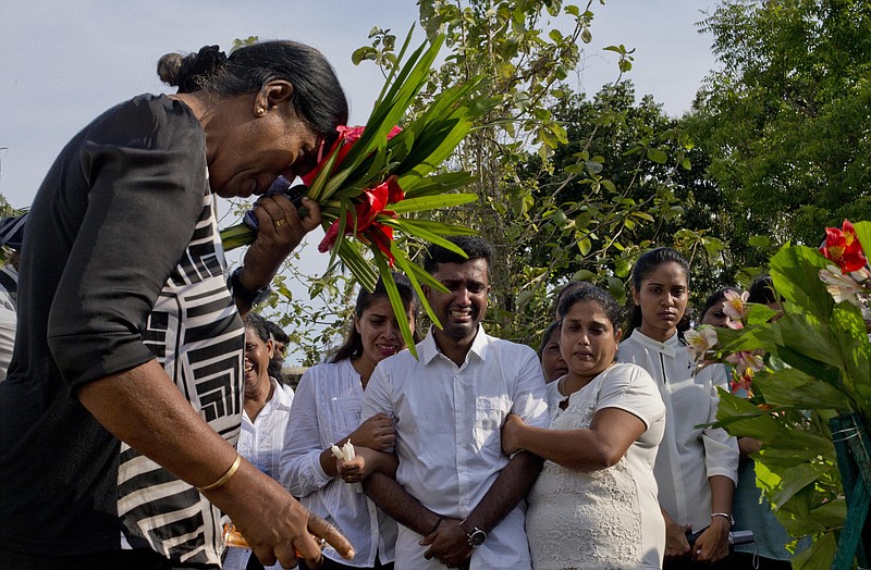 Nilanga Anthony, center, mourns the death of his seven-years old nephew Dhulodh Anthony, a victim of Easter Sunday bomb blast during the burial at Methodist cemetery in Negombo, Sri Lanka, Tuesday, April 23, 2019. (AP Photo/Gemunu Amarasinghe)