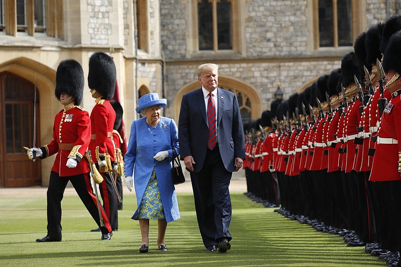 FILE - In this Friday, July 13, 2018 file photo, U.S. President Donald Trump and Britain's Queen Elizabeth inspects the Guard of Honour at Windsor Castle in Windsor, England. U.S. President Donald Trump will pay a state visit to Britain in June as a guest of Queen Elizabeth II, Buckingham Palace said Tuesday, April 23, 2019. The palace said Trump and his wife, Melania, had accepted an invitation from the queen for a visit that will take place June 3-5. (AP Photo/Pablo Martinez Monsivais, file)