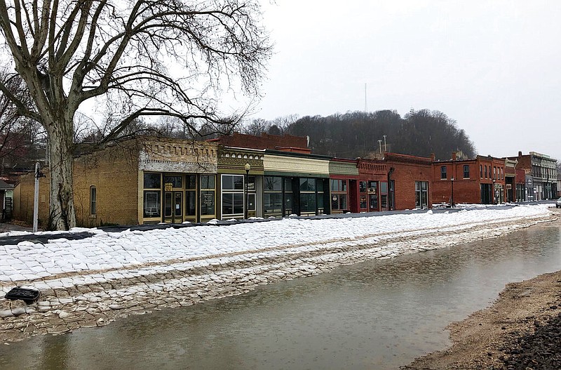 In this April 5, 2019, photo, streets are filled with sandbags and temporary levees in Clarksville, Mo. A wall made of sandbags and rocks was hurriedly built to protect the quaint downtown. 