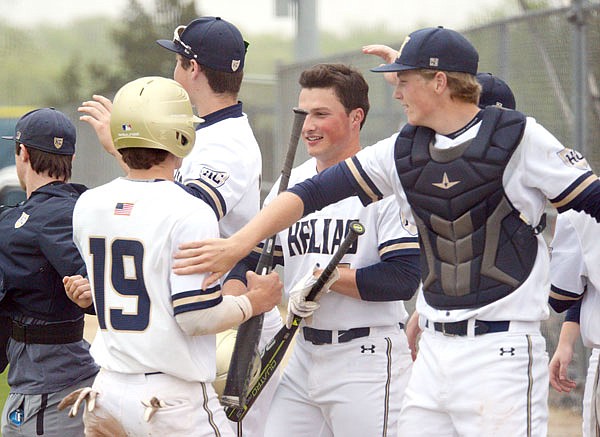 Trevor Austin (left) celebrates with his Helias teammates after he scored on a bases-clearing double in the second inning of Tuesday's game against Blair Oaks at the American Legion Post 5 Sports Complex. The Crusaders won 8-7 on a walk-off hit by Zach Davidson in the seventh inning.