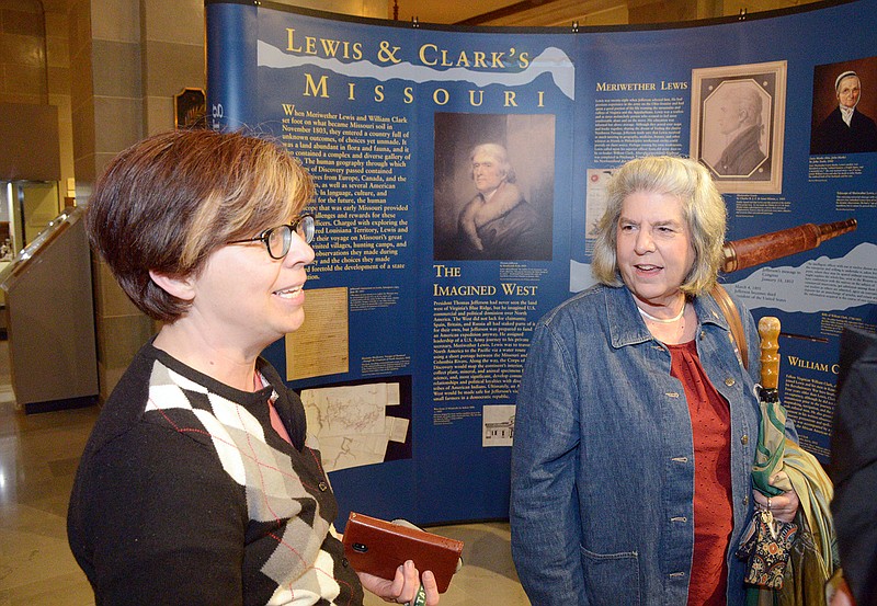 Tiffany Patterson, Director of the Missouri State Museum and Jefferson Landing, talks Tuesday to Janet Maurer, right, who helped organize the task force that helped build the Lewis and Clark monument, in the Missouri State Museum's History Hall during Jefferson and Generations at the Capitol.