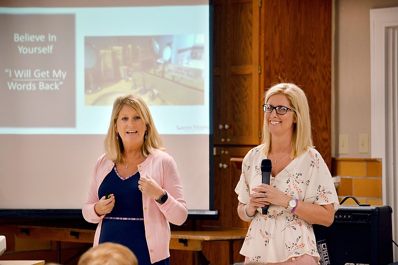 Motivational speaker Lauren Murphy, right, and her mother, Colleen, talk to students Wednesday at Immaculate Conception School. In 2013, Lauren was hit by a vehicle and suffered a traumatic brain injury. She has since worked to inspire those around to never give up.