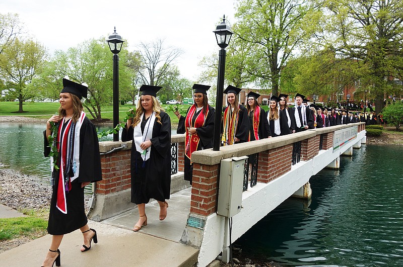 <p>Helen Wilbers/For the News Tribune</p><p>Led by senior class president Ashley Pendleton, members of William Woods University’s undergraduate class of 2019 cross Senior Pond. The ivy chain ceremony’s origins are murky, but date back to the school’s early days.</p>