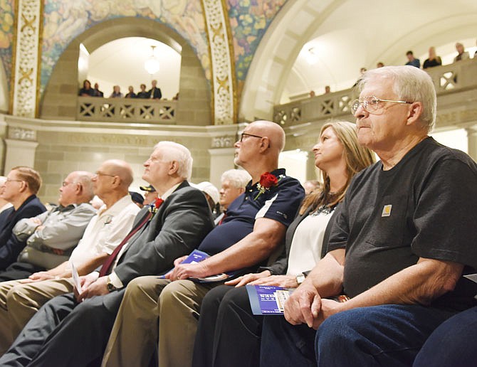U.S. Army veteran Michael Morgan, at right, was just one of hundreds of Vietnam veterans who were invited to the Capitol Thursday for the Vietnam War 50th anniversary Commemoration Ceremony. His daughter, Michelle Hallford, seated to his right, joined him in the recognition ceremony. The Rotunda was filled with veterans and proud family members who listened as elected officials and directors of state agencies addressed the full house of veteran visitors. 