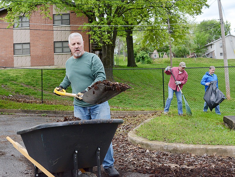 Charle Lindquist, with the First Church of Nazarene, scoops dead leaves into a barrel Saturday as he volunteers during a Serve Jefferson City project at the Little Explorers Discovery Center. Serve Jeff City gathers hundreds of volunteers every April to complete projects that benefit the environment and beautify the city. 