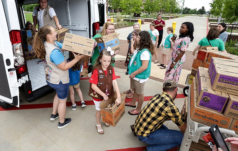 Girl Scouts unload a truck full of cookies Tuesday at Texas A&M University-Texarkana. Local Girl Scout Troops 2182 and 2413 donated 1,700 cookies to the university's student veterans as a thank you to the community and its support of Scouts who participated in the Girl Scout Cookie Program.
