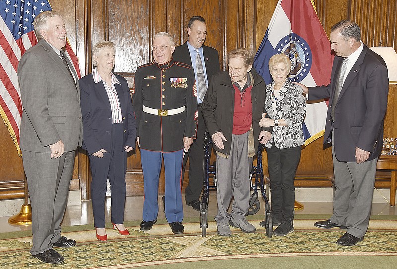 Gov. Mike Parson, far left, shares a laugh with Wednesday's two Silver Star recipients and their wives. Retired Marine Gunnery Sgt. Bryce Lockwood, third from left, and his wife Lois, along with U.S. Army veteran Herb Siebert, third from right, and his wife, Brenda, laugh along with Lt. Gov. Mike Kehoe, far right, after the presentation. In the middle is Jeremy P. Amick, who researches and writes on behalf of Silver Star Families of America
