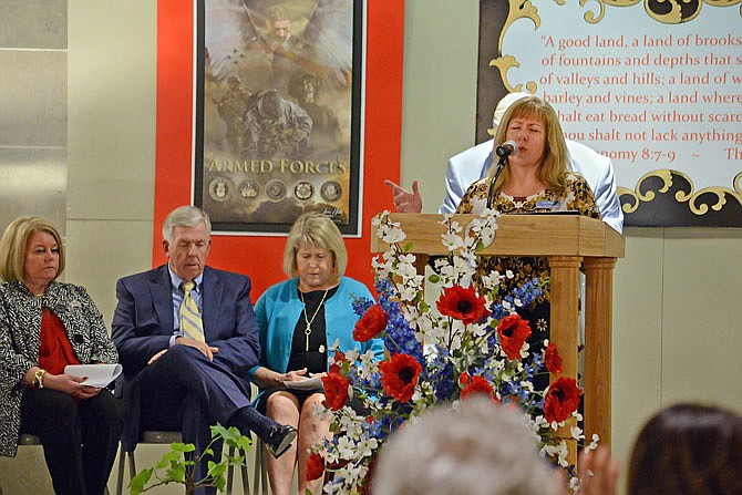 Lois Hogan leads the crowd in prayer Thursday during the National Day of Prayer celebration in the Capitol Rotunda. The National Day of Prayer exists to mobilize unified public prayer for America.