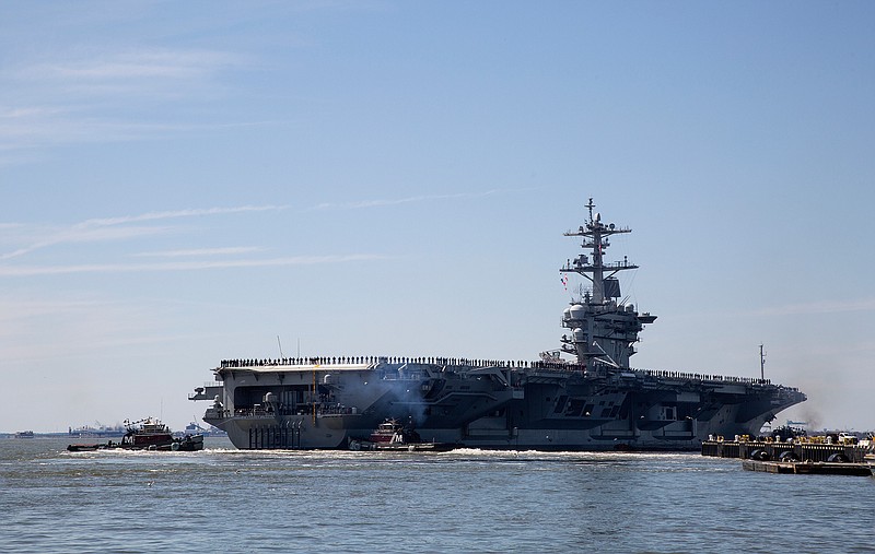 In this April 1, 2019, file photo, the USS Abraham Lincoln deploys from Naval Station Norfolk, in the vicinity of Norfolk, Va. The White House said Sunday, May 5, that the U.S. is deploying military resources to send a message to Iran. White House national security adviser John Bolton said in a statement that the U.S. is deploying the USS Abraham Lincoln Carrier Strike Group and a bomber task force to the U.S. Central Command region, an area that includes the Middle East. (Kaitlin McKeown/The Virginian-Pilot via AP, File)
