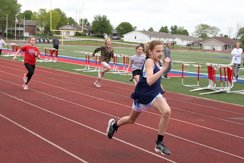 Fourth-grade girls run to the finish line in the 100-meter dash at the Lions Club Track Meet on May 3, 2019, at California High School.