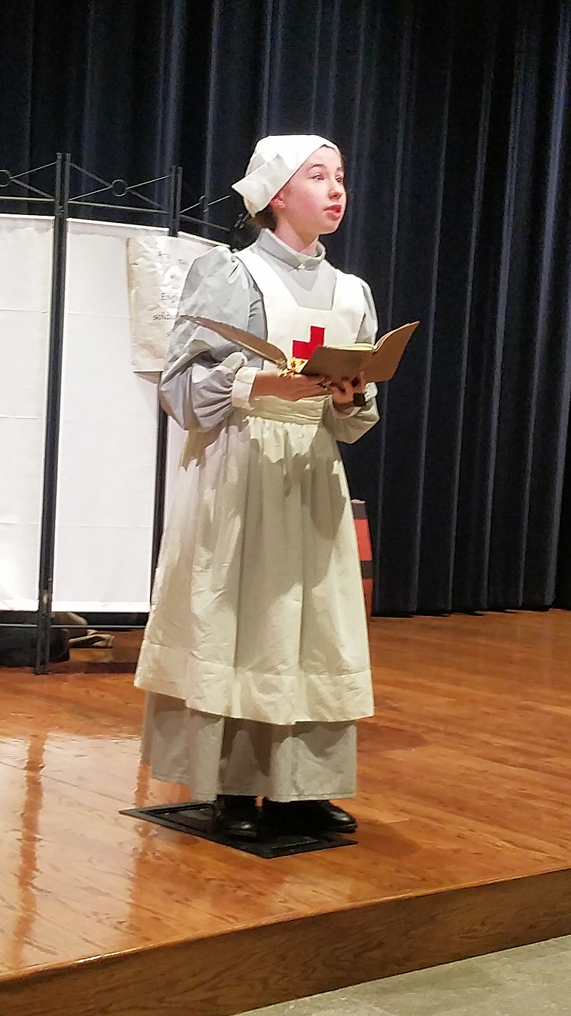 Maria Brown, a Blair Oaks Middle School student, performs during her presentation on British World War I Red Cross nurse Edith Cavell.