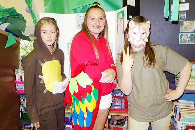 Greta Patten, Adrianna Branch and Kirsten Harris strike a pose. They and their fifth-grade classmates used newly learned research skills to learn about and present on rainforest animals.