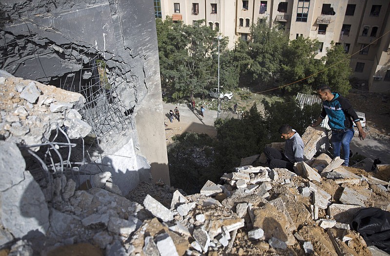 Palestinians inspect the damage of a destroyed house following a late night Israeli missile strike in town of Beit Lahiya, Northern Gaza Strip, Monday, May. 6, 2019. The Israeli military has lifted protective restrictions on residents in southern Israel while Gaza's ruling Hamas militant group reported a cease-fire deal had been reached to end the deadliest fighting between the two sides since a 2014 war.