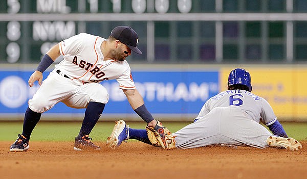 Astros second baseman Jose Altuve is late with the tag as  Billy Hamilton of the Royals is safe with a steal at second base during the fifth inning of Monday night's game in Houston.