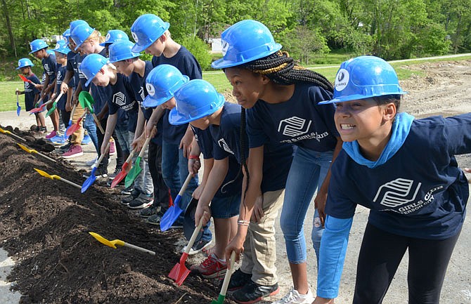 Children from the Boys & Girls Club of Jefferson City, donning plastic hard hats, break ground at Community Park on Tuesday. Community Park is the first of many major improvement projects outlined in the Parks, Recreation, and Forestry Master Plan.