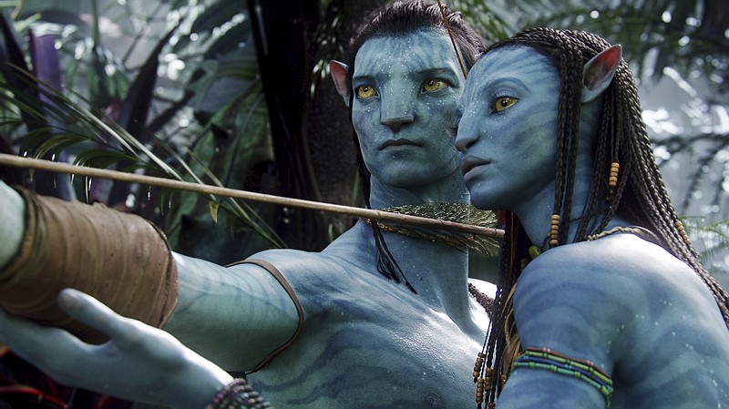 FILE - This image released by 20th Century Fox shows the characters Neytiri, right, and Jake in a scene from the 2009 movie "Avatar." The Walt Disney Co. on Tuesday laid out its plans for upcoming 20th Century Fox films. James Cameron’s long-delayed “Avatar 2” will now open in theaters in December 2021 instead of its most recent date of December 2020. The two subsequent “Avatar” sequels will move to 2023 and 2025, respectively. (AP Photo/20th Century Fox, File)