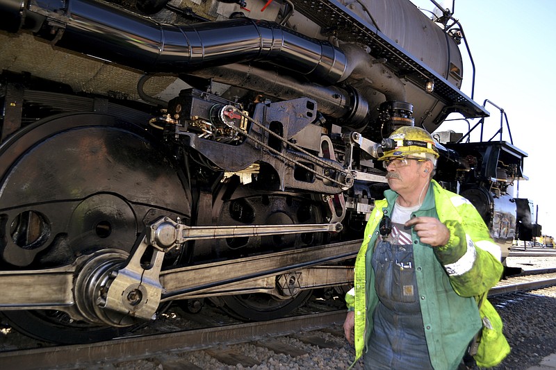 A worker walks past the wheels on the Big Boy No. 4014 at a Union Pacific restoration shop at the Cheyenne Depot Museum in Cheyenne, Wyo., Saturday, May 4, 2019. One of the world's biggest and most powerful steam locomotives is chugging to its big debut after five years of restoration work. From there, it goes to Ogden, Utah, to help celebrate the 150th anniversary of the Transcontinental Railroad. (AP Photo/P. Solomon Banda)