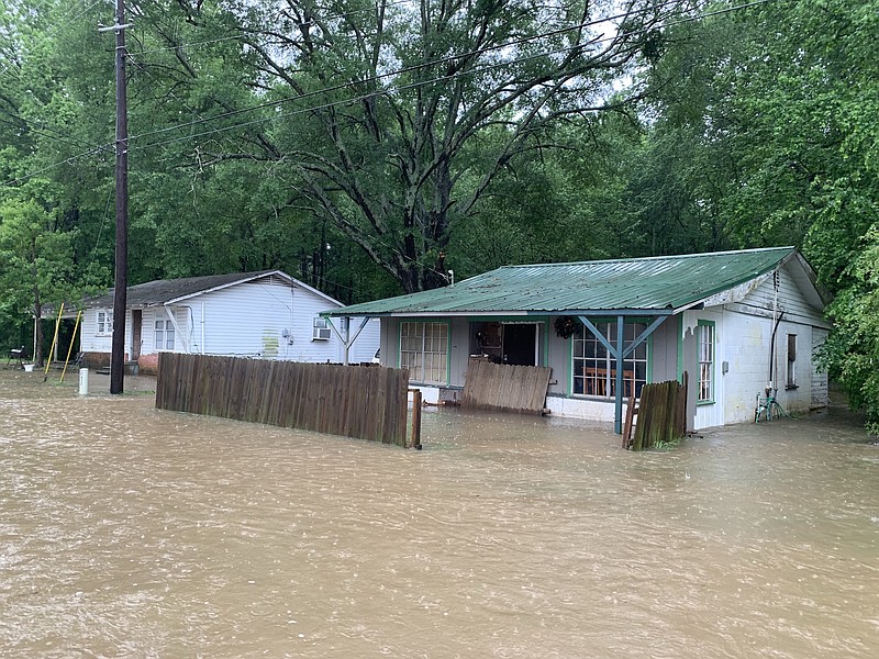 Houses along East Thomas Street are flooded from heavy thunderstorms and flash flooding on Wednesday, May 8, 2019, in Atlanta, Texas. 
