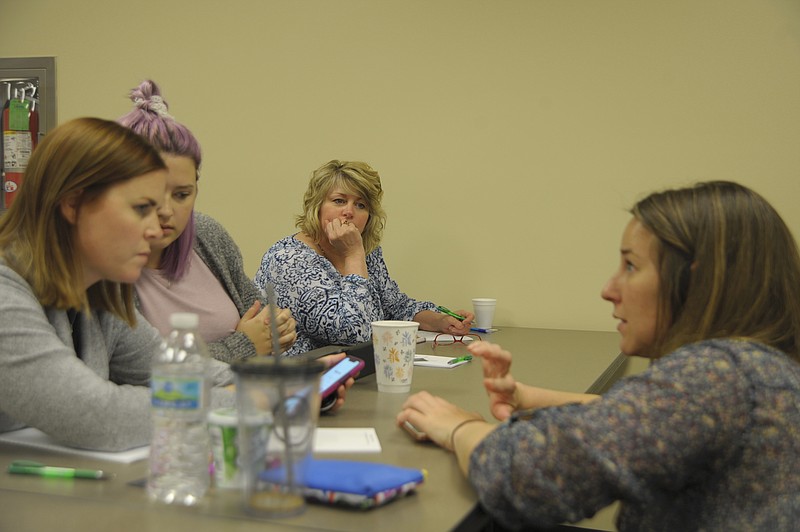 Jenny Cain works with Sarah Bohl on her Instagram account at the California Chamber of Commerce social media training with Dogwood Social. Robin Arnold and Rebecca Hamilton look on.