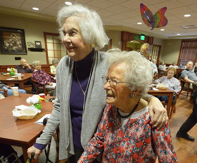 Jessie Schell, and Sue Strong, left, chat, as family and friends celebrate Schell's 103rd birthday Thursday at Primrose Retirement Community.