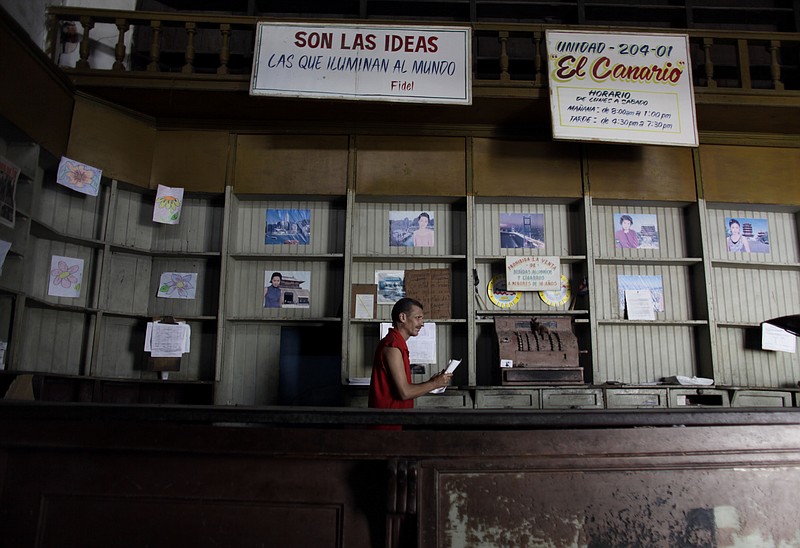 In this Oct. 9, 2009 file photo, an employee works in a government food store with empty shelves in Havana, Cuba. The Cuban government said, Friday, May 10, 2019, that it will begin rationing chicken, eggs, rice, beans, soap and other basic products in the face of a grave economic crisis. (AP Photo/Javier Galeano, File)