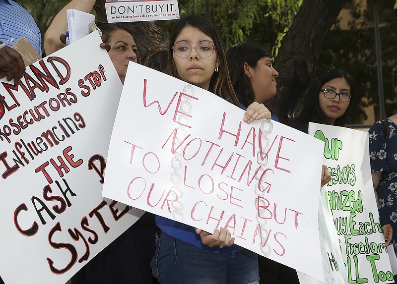  Annette Alvarez, middle, joins other protesters as they gather in front of Maricopa County Attorney Bill Montgomery's office Thursday, May 9, 2019, in Phoenix. For Mother's Day, dozens of mothers are getting time with their children instead of time behind bars as the National Bail Out Collective is organizing its "Black Mama's Bail Out" initiative to post bail for women of color who would otherwise be in jail. (AP Photo/Ross D. Franklin)