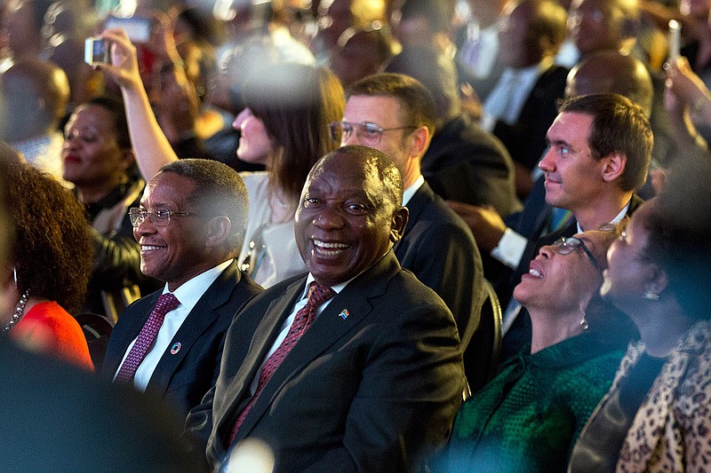 South Africa President Cyril Ramaphosa, center, celebrates after the Independent Electoral Commission announced the final results in South Africa's general election in Pretoria, Saturday, May 11, 2019. South Africans voted Wednesday in a national election and results show that the ruling African National Congress party (ANC) has won the national elections but has seen its share of the vote drop significantly. (AP Photo/Jerome Delay)