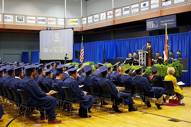 Naomi Klouzek, 1994 drafting graduate, stands at the podium as she speaks to the class of 2019 Saturday during the graduation ceremony at State Technical College in Linn. 