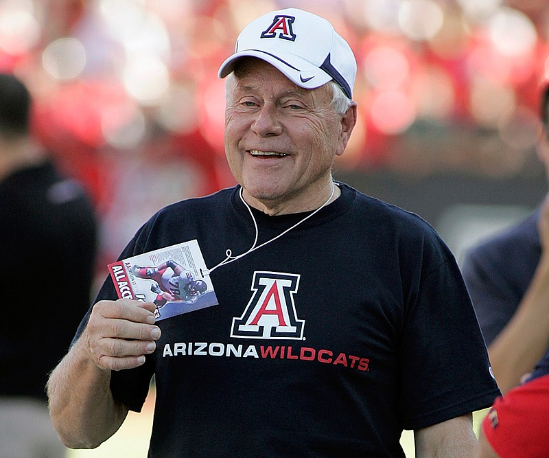 In this Oct. 9, 2010, file photo, former Arizona football head coach Dick Tomey, is seen back in Arizona Stadium for the 1st time since 2000, jokes on the sidelines before the NCAA college football game against Oregon State in Tucson, Ariz. Tomey, the winningest football coach in University of Arizona history, died Friday night, May 10, 2019, in Tucson, Ariz. He was 80. Tomey was 183-145-7 overall in 20 years as head coach at Hawaii, Arizona and San Jose State. He was diagnosed with lung cancer in December.   (AP Photo/John Miller, File)