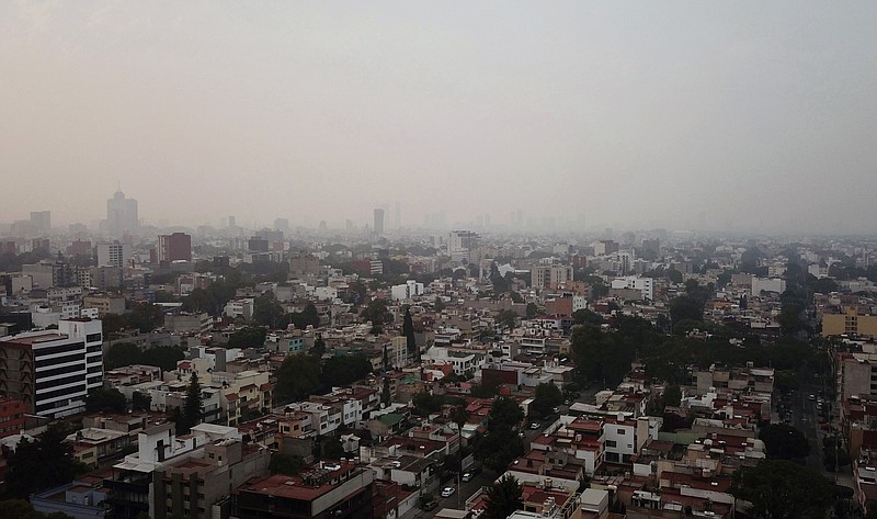 Smoke covers Mexico City, Sunday, May 12, 2019. Mexico City has warned residents to remain indoors as forest and brush fires carpet the metropolis in smoke. (AP Photo/Christian Palma)