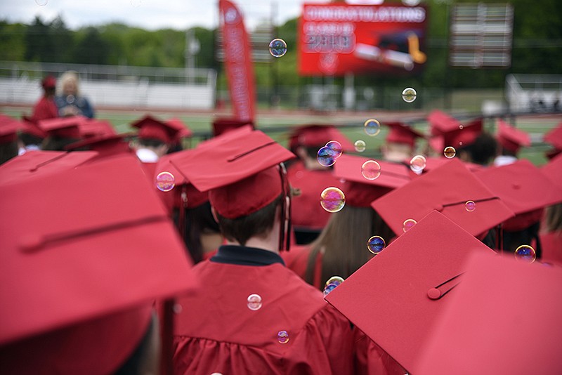 Bubbles blow in the air during the Jefferson City High School commencement ceremony on Sunday, May 12, 2019, at Adkins Stadium. Some students snuck in bubbles and beach balls to throw during the ceremony. 