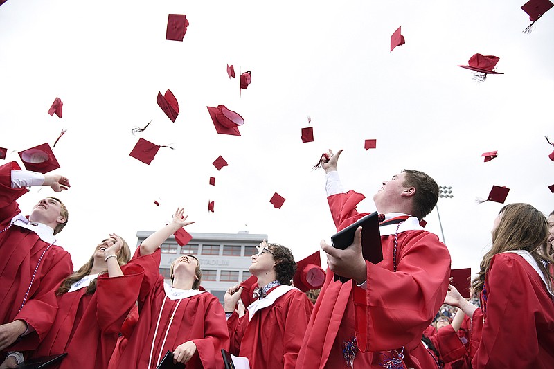 Graduates of Jefferson City High School toss their graduation caps in the air at the end of the commencement ceremony Sunday at Adkins stadium. 